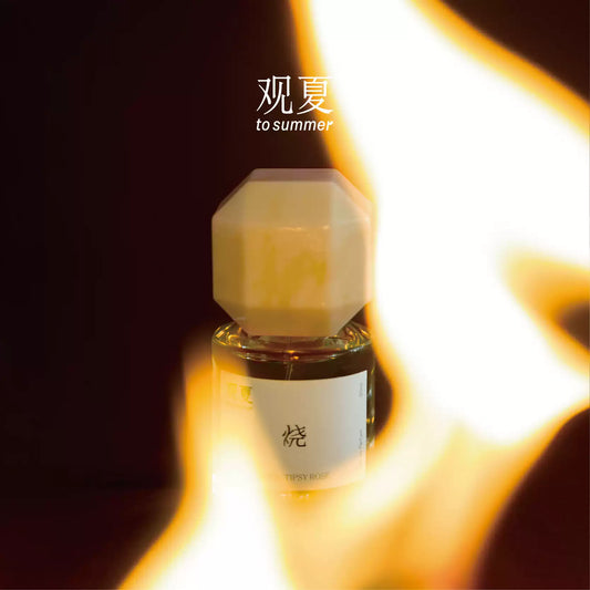 To Summer TIPSY ROSE niche perfume bottle glowing in warm light, perfect scent for romantic date nights.