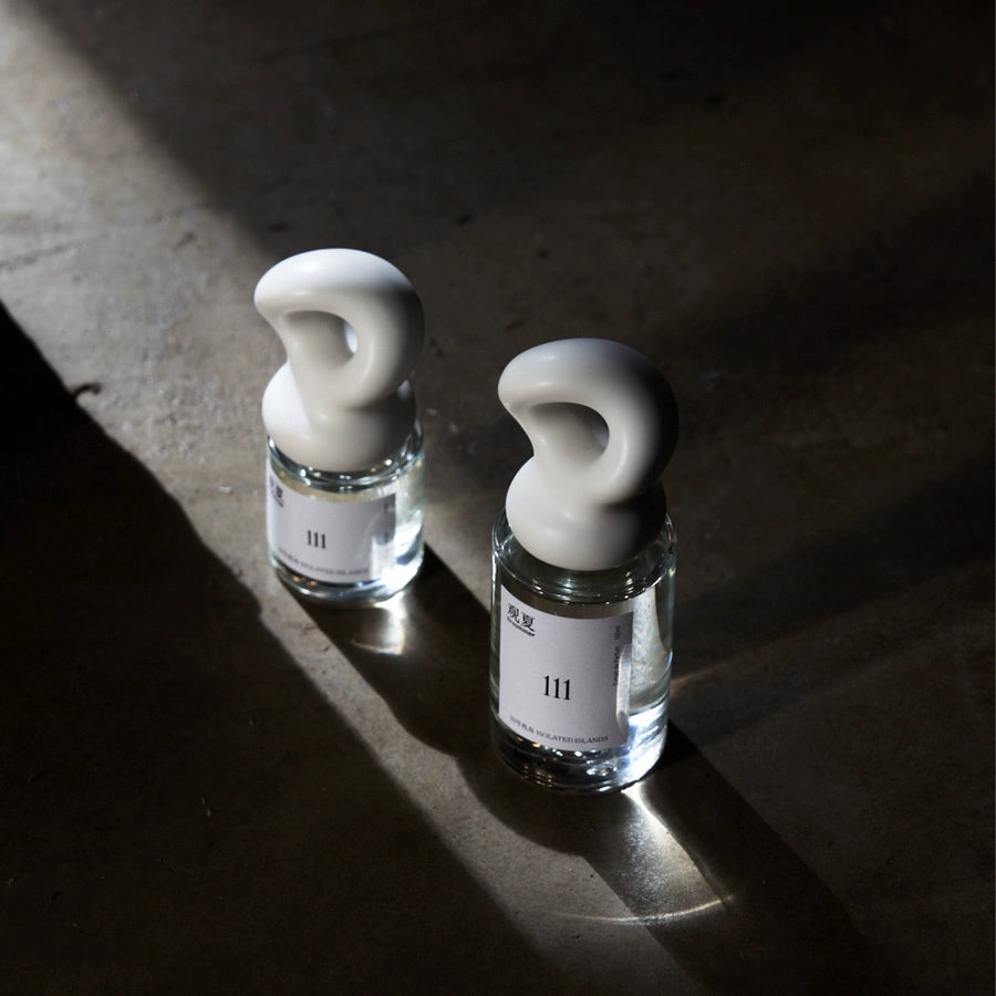 To Summer 111 ISOLATED ISLANDS perfume bottle in soft light, representing a clean summer aesthetic.
