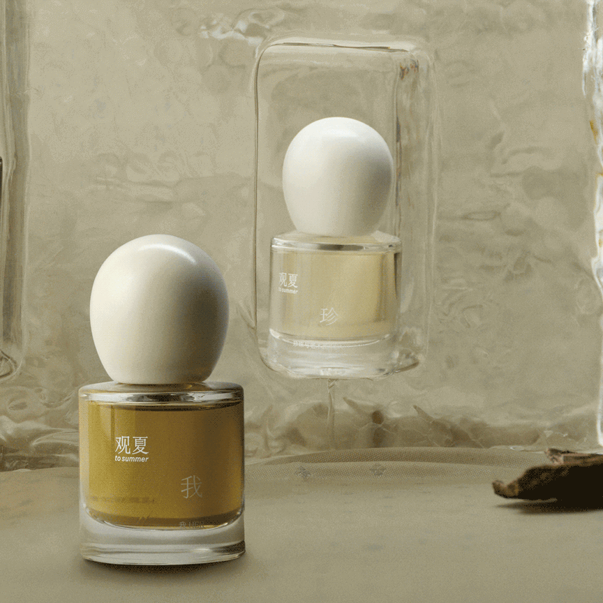 To Summer HER and PEARL BOX perfume bottles displayed together, a collection of woody and floral scents.