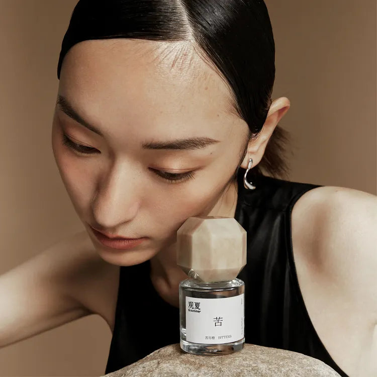 Elegant model wearing To Summer BITTERS perfume, capturing a moment of calm focus and clarity.