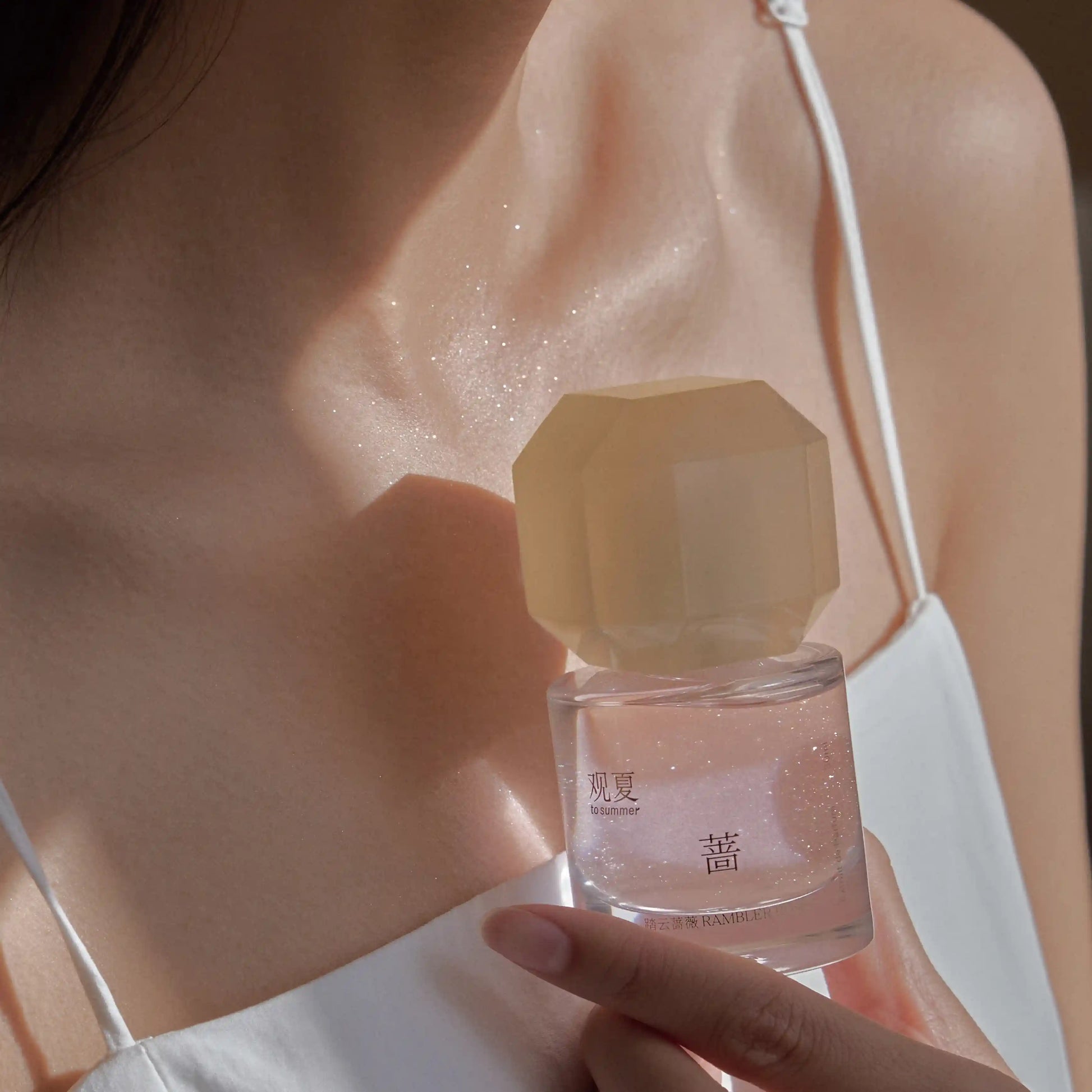 RAMBLER ROSE perfume worn on skin, showing a soft woody floral rose scent with green freshness