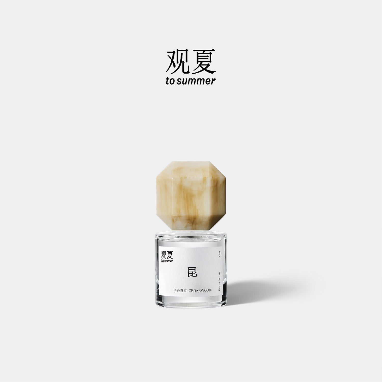 A hand holding To Summer CEDARWOOD perfume near the neck, creating a mindful and intimate mood.