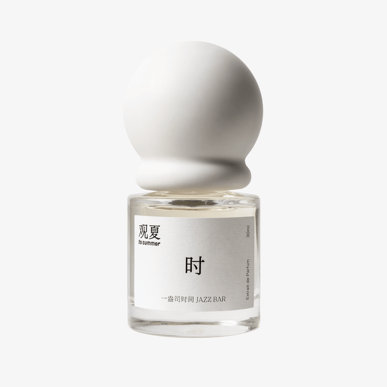 To Summer JAZZBAR perfume bottle with white cap, featuring an intoxicating boozy and woody scent.