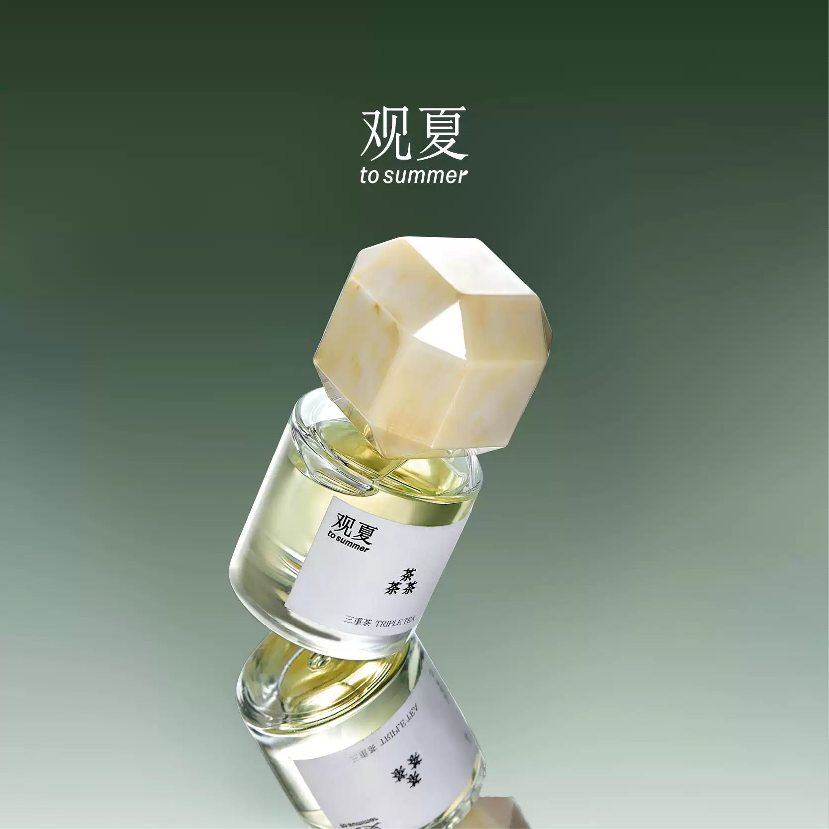 To Summer Triple Tea perfume bottle with beige marble cap reflected on a mirrored surface, against a green gradient background.